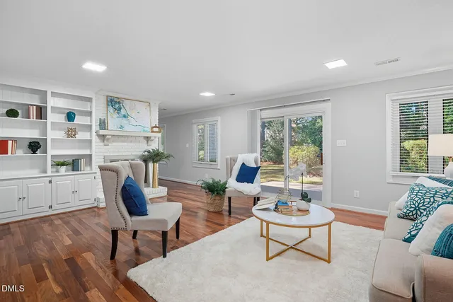 a living room with furniture a rug and a large window