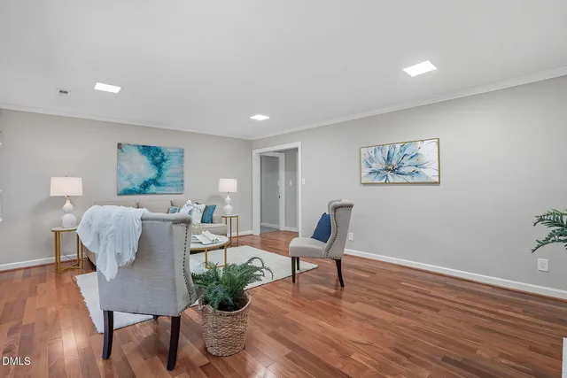 a living room with furniture and wooden floor