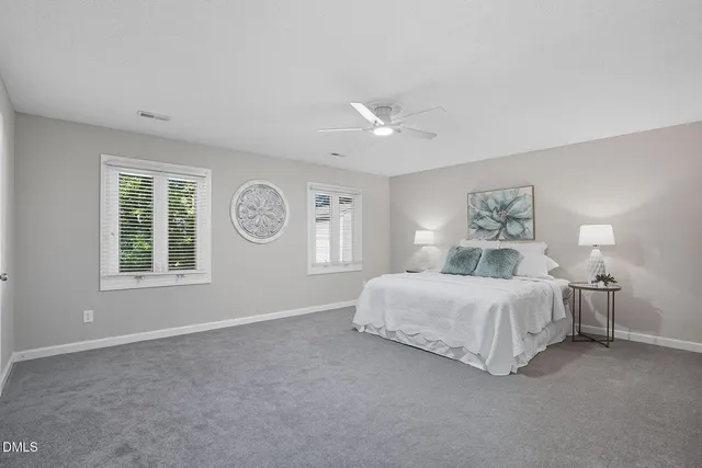 a spacious bedroom with a bed and a window