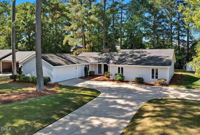 a view of a house with a yard and tree s