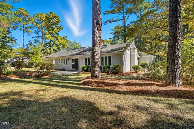 a view of a house with a tree in the yard