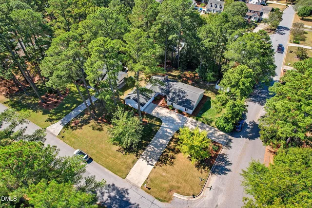 an aerial view of residential house with yard and swimming pool