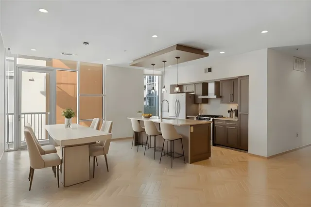 a large kitchen with a table and chairs