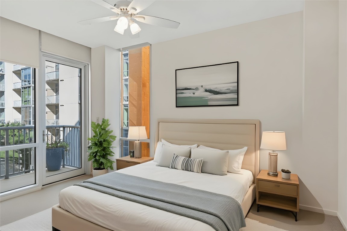 1600 Barton Springs Road, Unit 5301 Austin, TX 78704 - Photo 6 of 30 a bedroom with a large bed and a chandelier