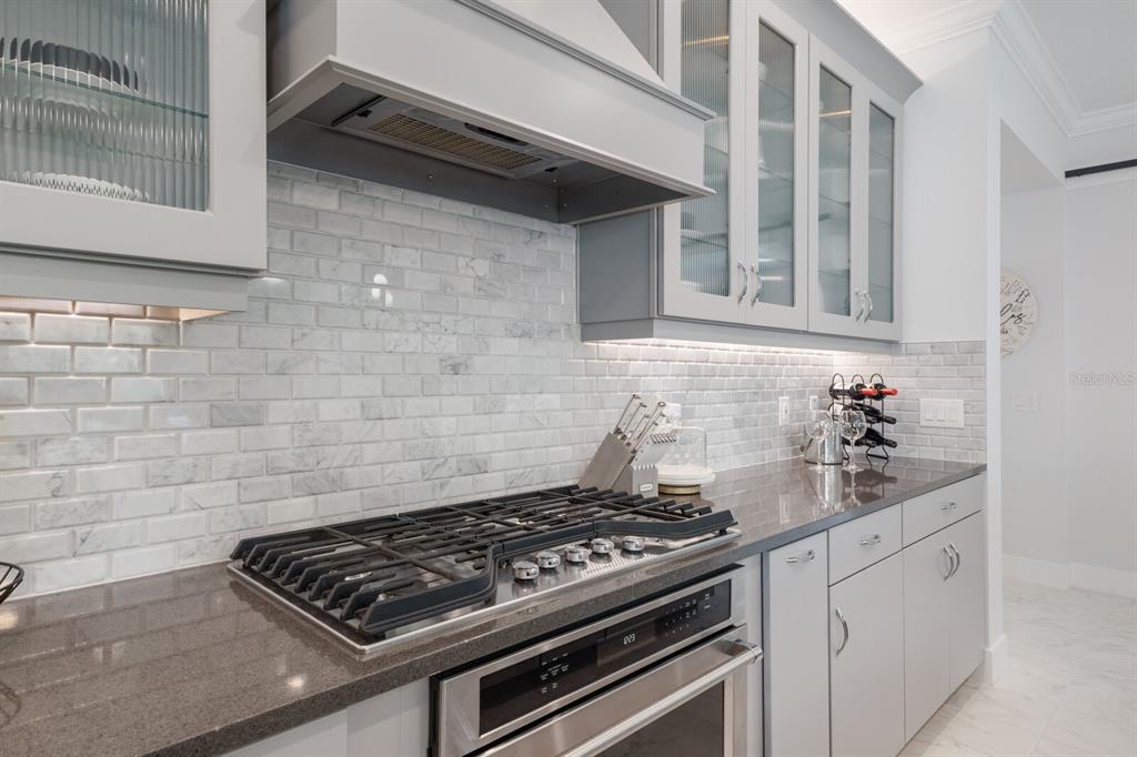 5557 Long Shore Loop Sarasota, FL 34238 - Photo 21 of 90 a stove top oven sitting inside of a kitchen