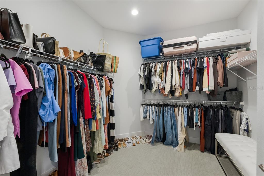 5557 Long Shore Loop Sarasota, FL 34238 - Photo 28 of 90 a view of walk in closet with clothes and shoes