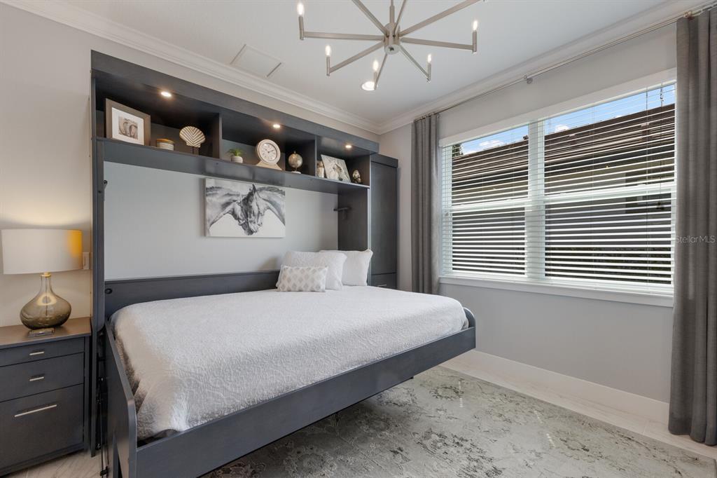 5557 Long Shore Loop Sarasota, FL 34238 - Photo 38 of 90 a bedroom with a large bed and a window