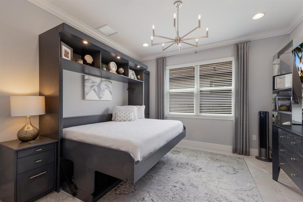 5557 Long Shore Loop Sarasota, FL 34238 - Photo 41 of 90 a bedroom with a bed and window