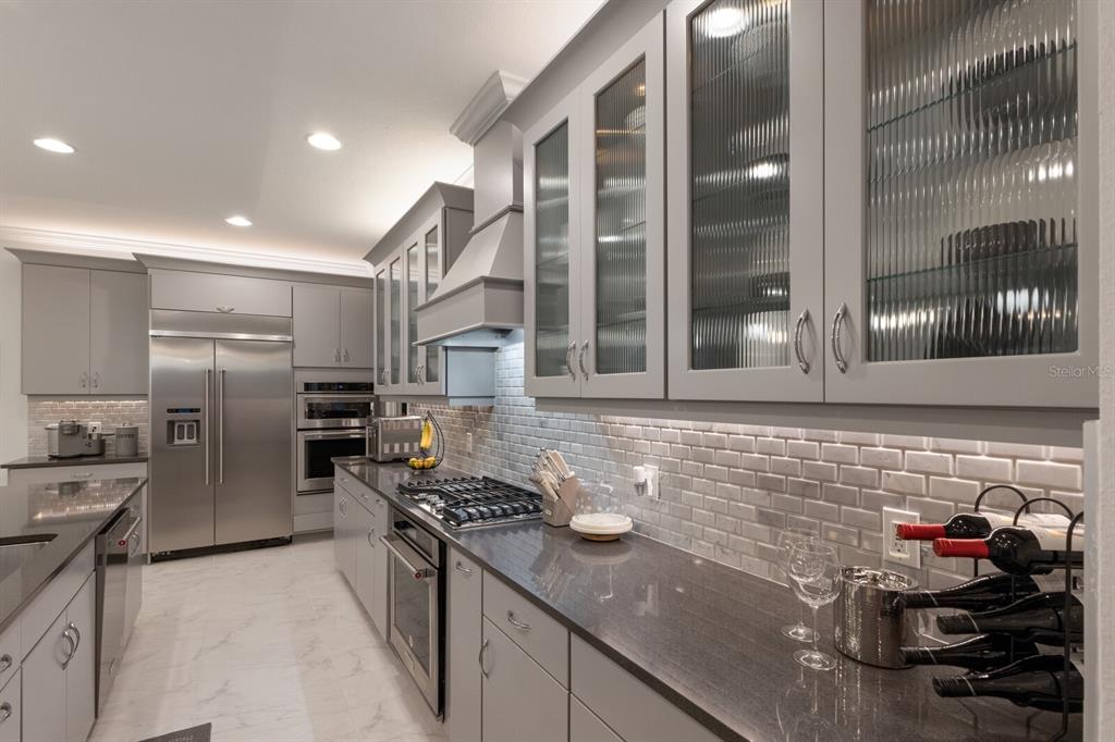 5557 Long Shore Loop Sarasota, FL 34238 - Photo 56 of 90 a kitchen with refrigerator and stove