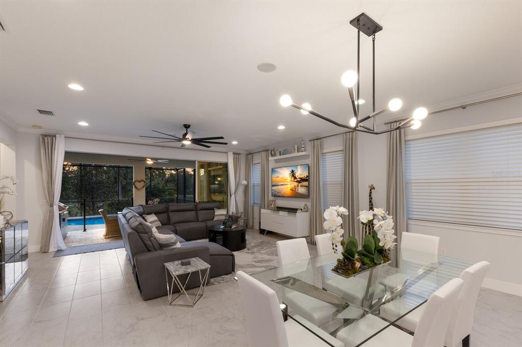 5557 Long Shore Loop Sarasota, FL 34238 - Photo 60 of 90 a living room with furniture and a chandelier