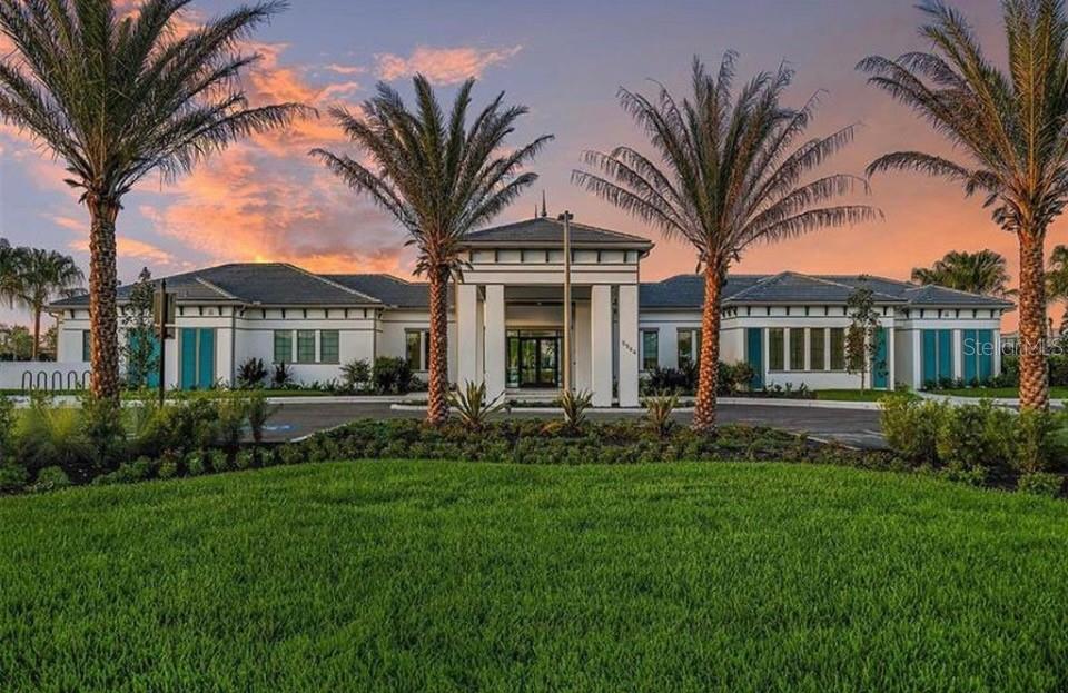 5557 Long Shore Loop Sarasota, FL 34238 - Photo 69 of 90 a front view of a house with a garden