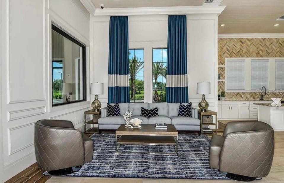 5557 Long Shore Loop Sarasota, FL 34238 - Photo 72 of 90 a living room with fireplace furniture and a floor to ceiling window