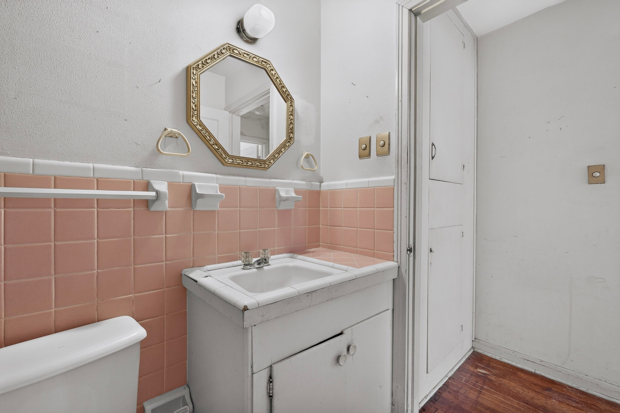 4703 Leslie Avenue Austin, TX 78721 - Photo 14 of 34 Pink tile accents and wood floors lend character to this functional washroom.