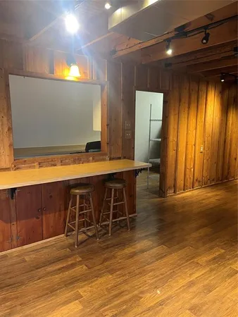 a view of a room with wooden floor