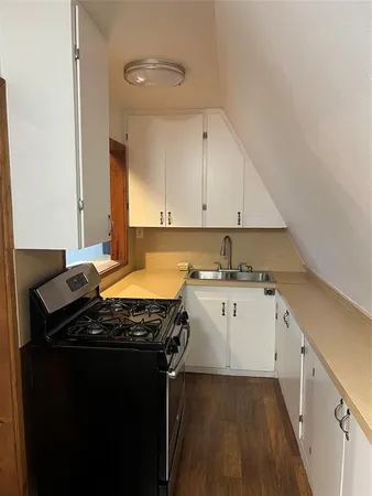 a kitchen with a sink stove and cabinets