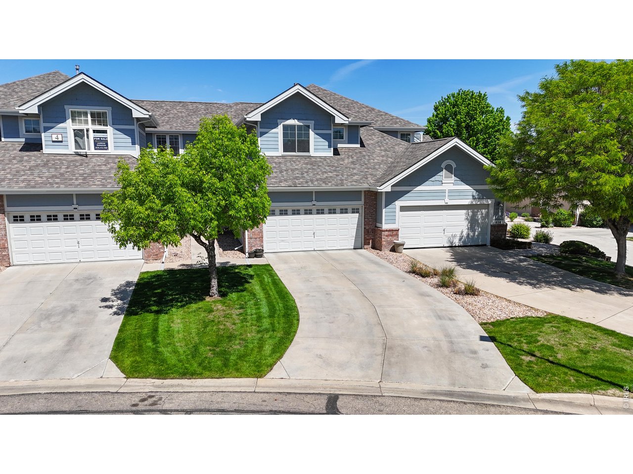 4672 West 20th Road, Unit 413 Greeley, CO 80634 - Photo 1 of 37 a front view of a house with a yard