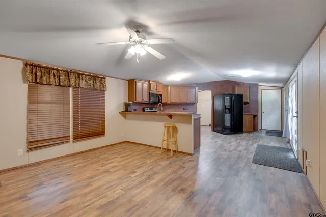 a view of kitchen with refrigerator and microwave