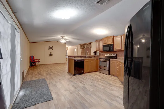 a kitchen with refrigerator and cabinets