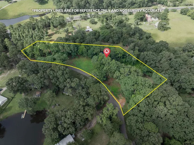 an aerial view of a houses with outdoor space and lake view