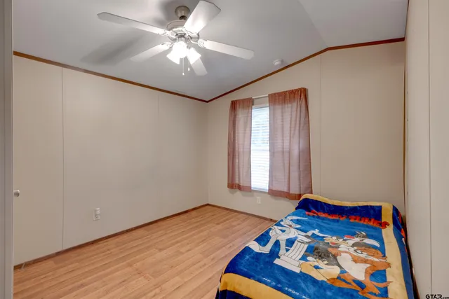a bedroom with a bed and a chandelier