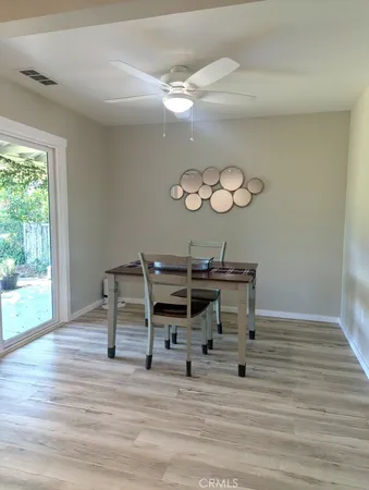 a kitchen with stainless steel appliances white cabinets and wooden floor