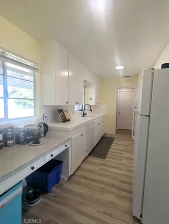 a view of walk in closet with wooden floor