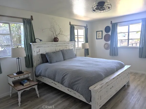 a bedroom with a bed and closet with mirror
