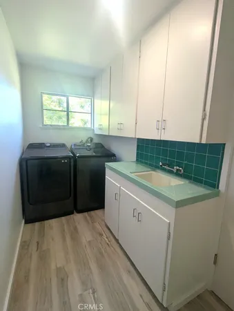 a kitchen with a cabinets and white appliances