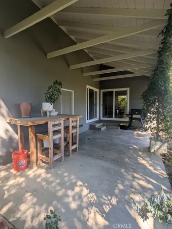 a view of a room with wooden floor and furniture
