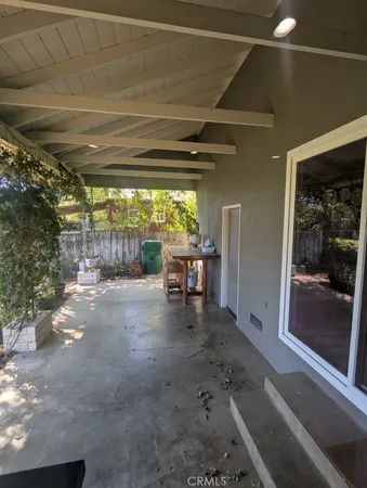 a view of a chairs and table in patio