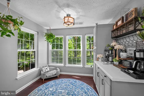 a very nice looking room with many windows and furniture