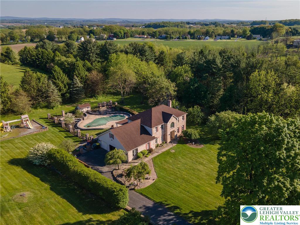 2170 Clearview Road Coplay, PA 18037 - Photo 11 of 75 Nestled in expansive greenery, this elegant estate offers an inviting pool, ideal for vibrant outdoor living.