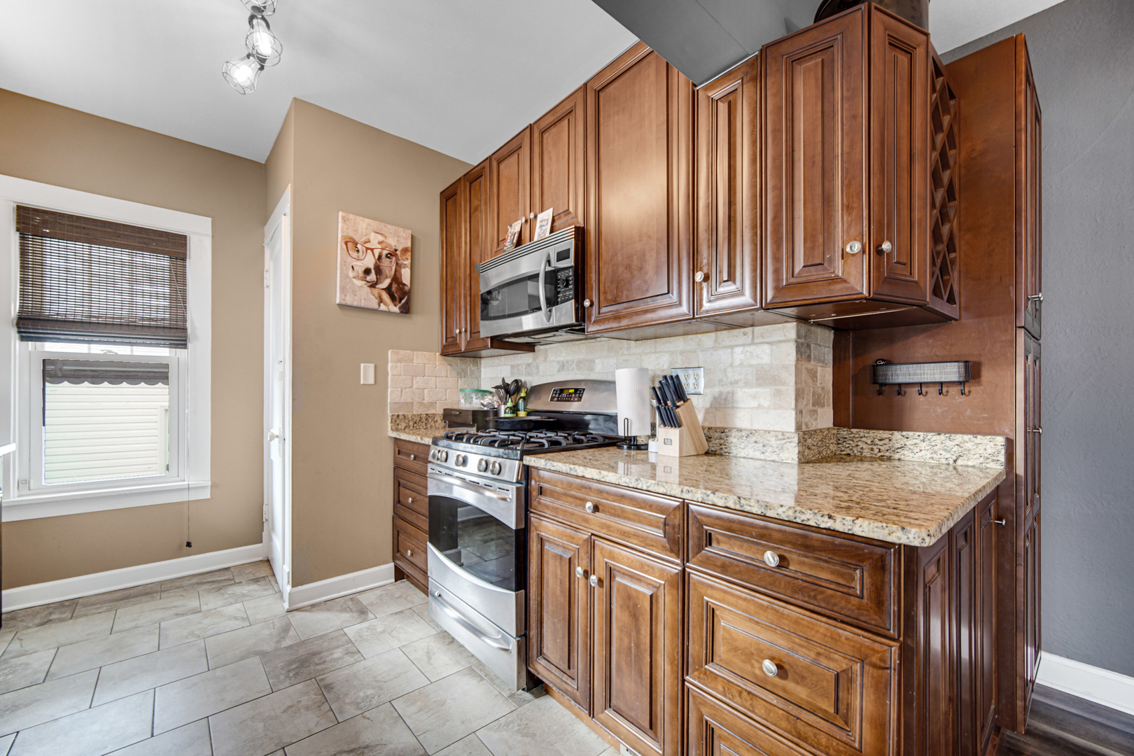 505 North William Street Joliet, IL 60435 - Photo 8 of 22 a kitchen with stainless steel appliances granite countertop a stove a sink and a refrigerator