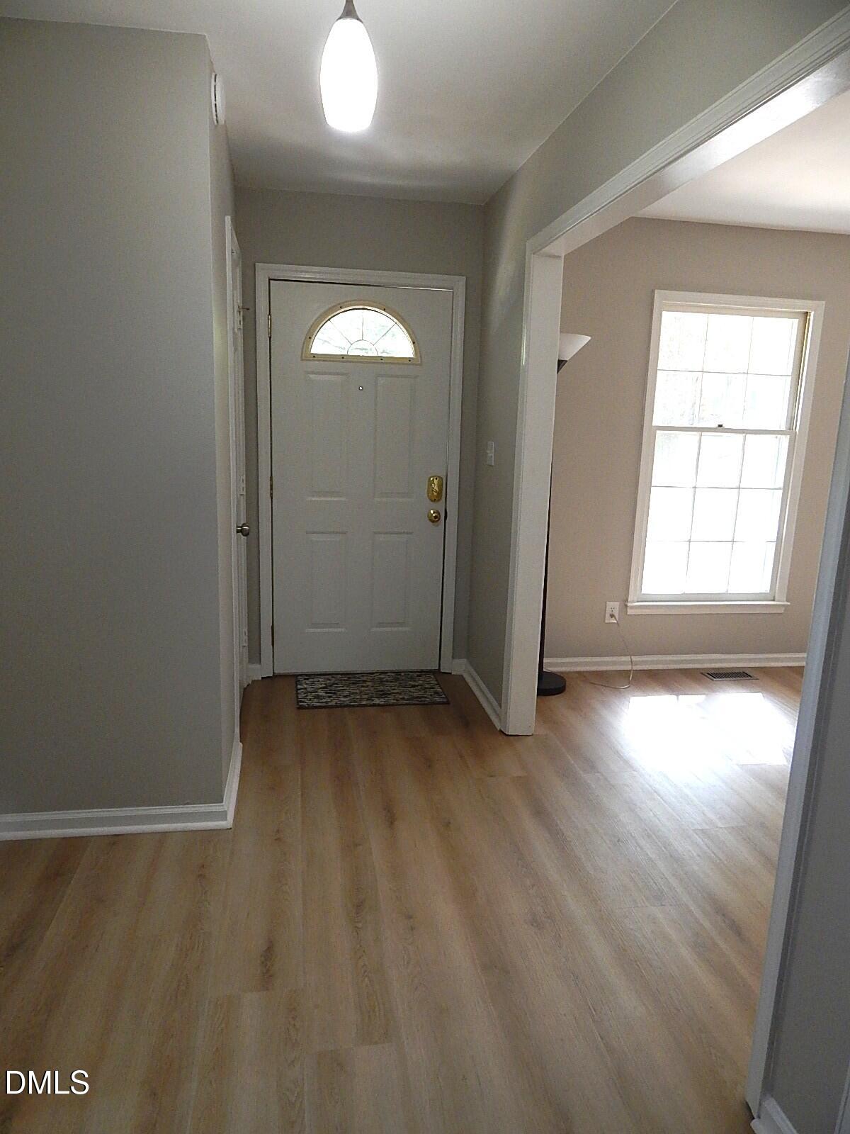 6408 Shadow Court Raleigh, NC 27613 - Photo 13 of 35 an empty room with wooden floor and windows