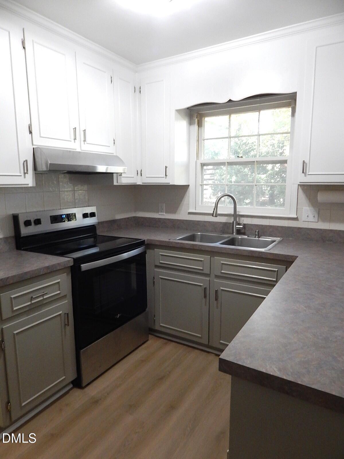 6408 Shadow Court Raleigh, NC 27613 - Photo 15 of 35 a kitchen with stainless steel appliances granite countertop a sink a stove and a microwave