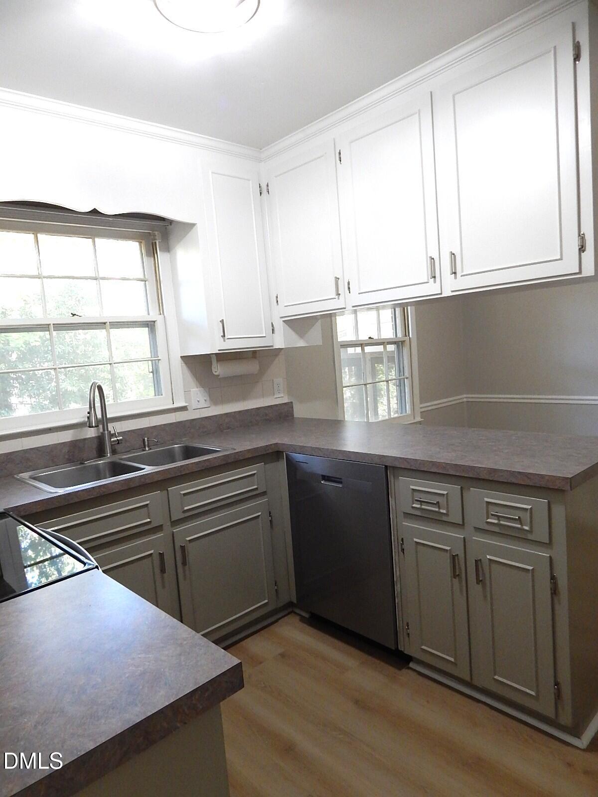 6408 Shadow Court Raleigh, NC 27613 - Photo 16 of 35 a kitchen with stainless steel appliances granite countertop a sink a stove and cabinets