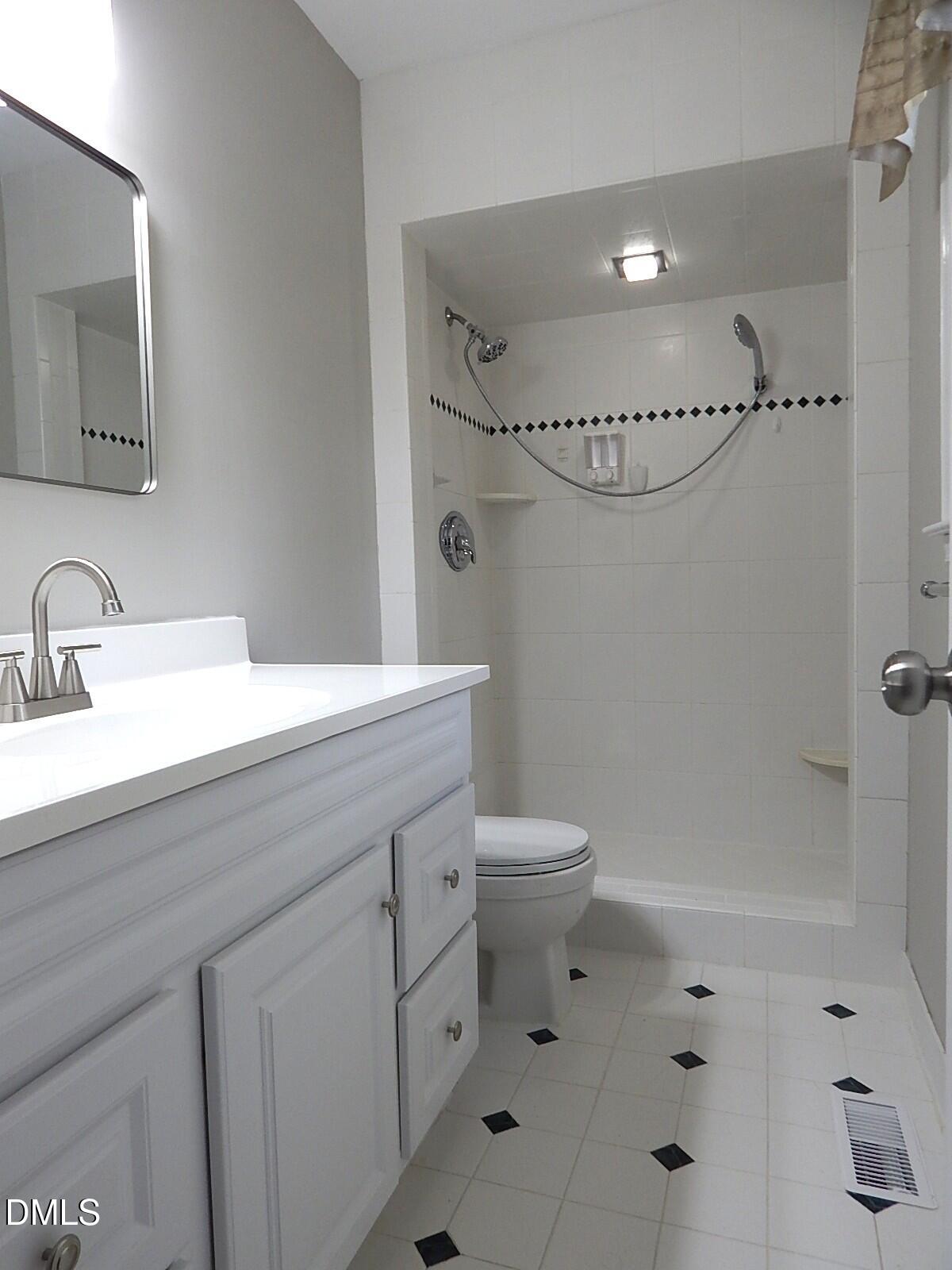 6408 Shadow Court Raleigh, NC 27613 - Photo 21 of 35 a bathroom with a sink a toilet and shower