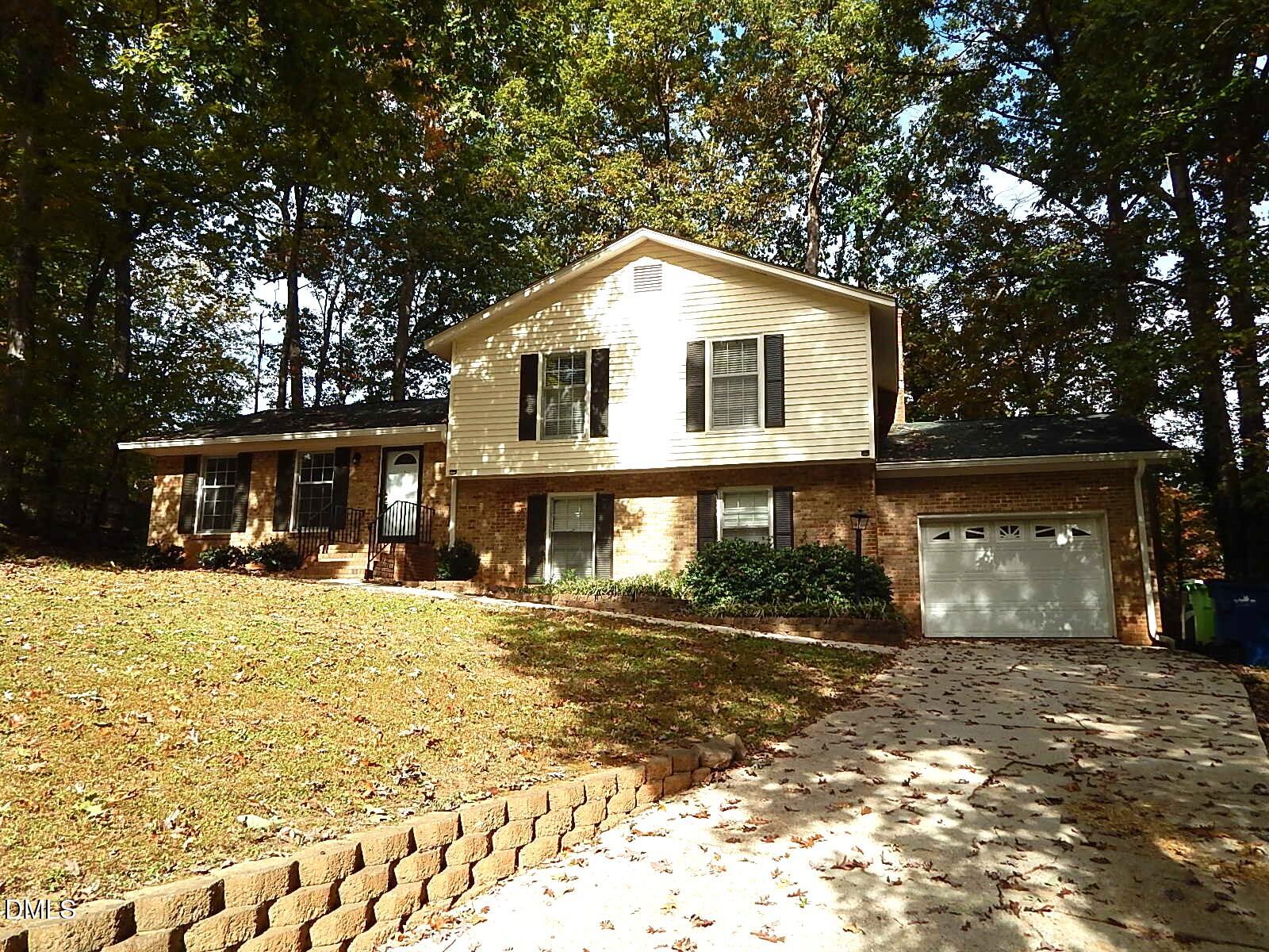6408 Shadow Court Raleigh, NC 27613 - Photo 3 of 35 a front view of a house with a yard covered with snow