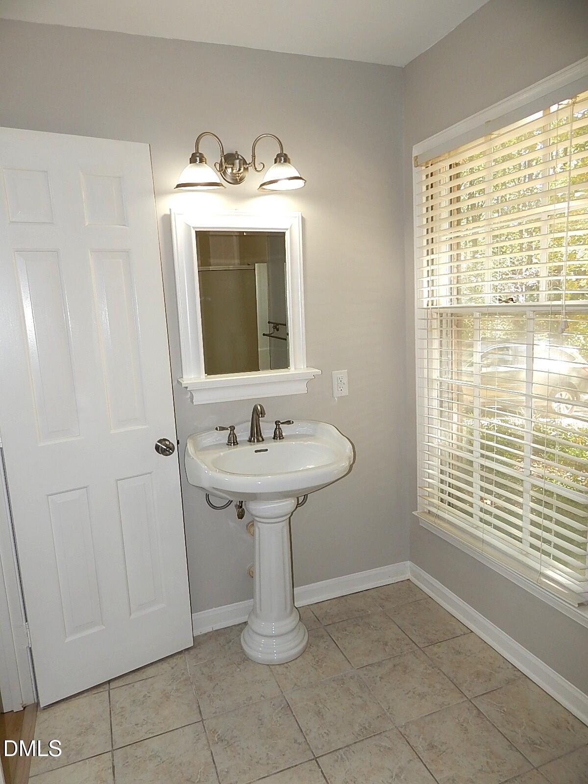 6408 Shadow Court Raleigh, NC 27613 - Photo 31 of 35 a bathroom with a sink a vanity and a mirror