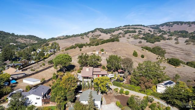 an aerial view of a house with a yard and garden