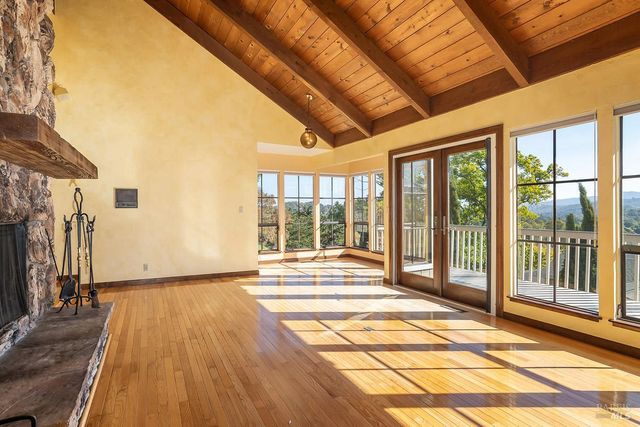 a view of a room with wooden floor and windows