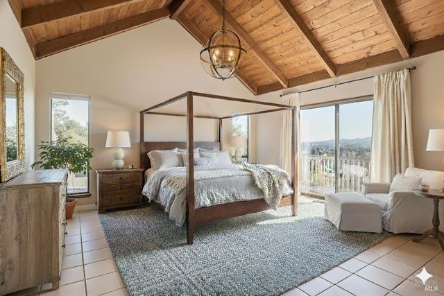 a bedroom with a bed and a large window