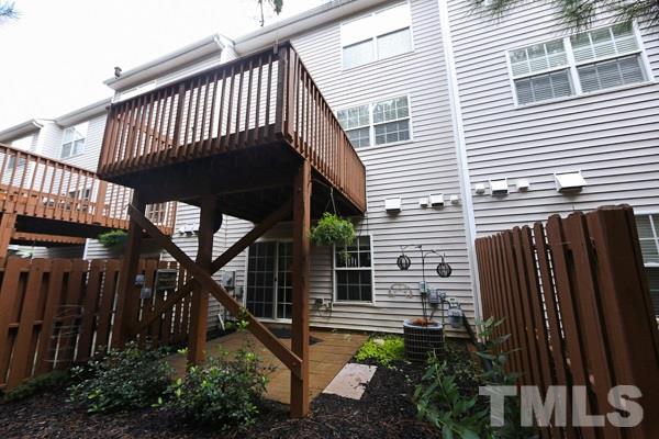 5422 Echo Ridge Road Raleigh, NC 27612 - Photo 13 of 14 a view of a backyard with plants and wooden fence