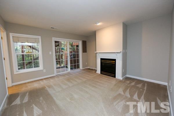 5422 Echo Ridge Road Raleigh, NC 27612 - Photo 2 of 14 a view of an empty room with a window and fireplace