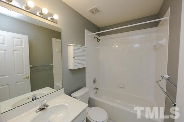 5422 Echo Ridge Road Raleigh, NC 27612 - Photo 8 of 14 a bathroom with a bathtub shower sink vanity and toilet