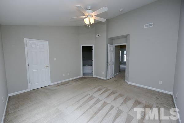 5422 Echo Ridge Road Raleigh, NC 27612 - Photo 9 of 14 a view of an empty room with a ceiling fan