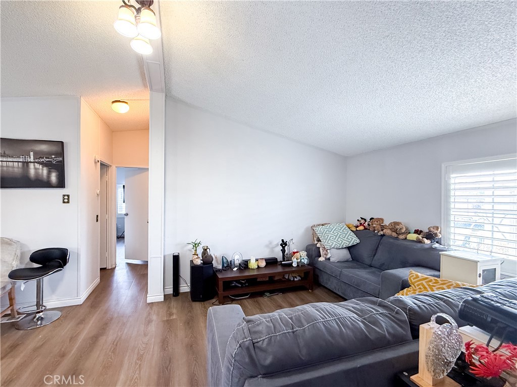 1855 East Riverside, Unit 130 Ontario, CA 91761 - Photo 14 of 62 a living room with furniture and wooden floor