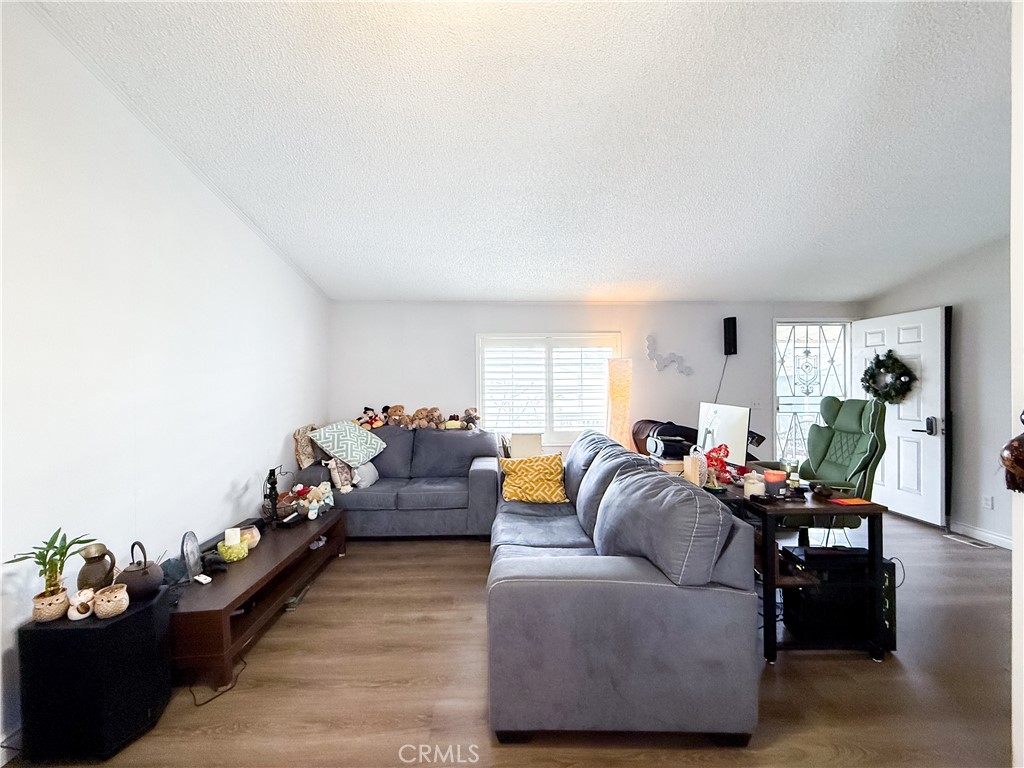 1855 East Riverside, Unit 130 Ontario, CA 91761 - Photo 15 of 62 a living room with furniture and wooden floor