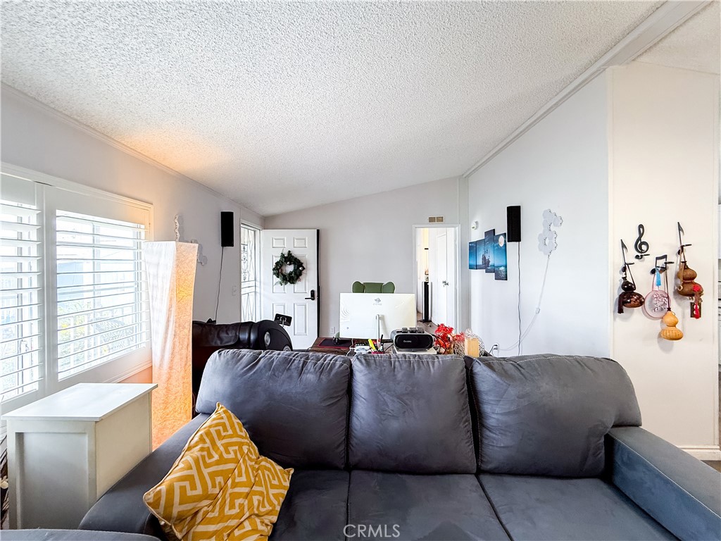 1855 East Riverside, Unit 130 Ontario, CA 91761 - Photo 16 of 62 a living room with furniture and a large window