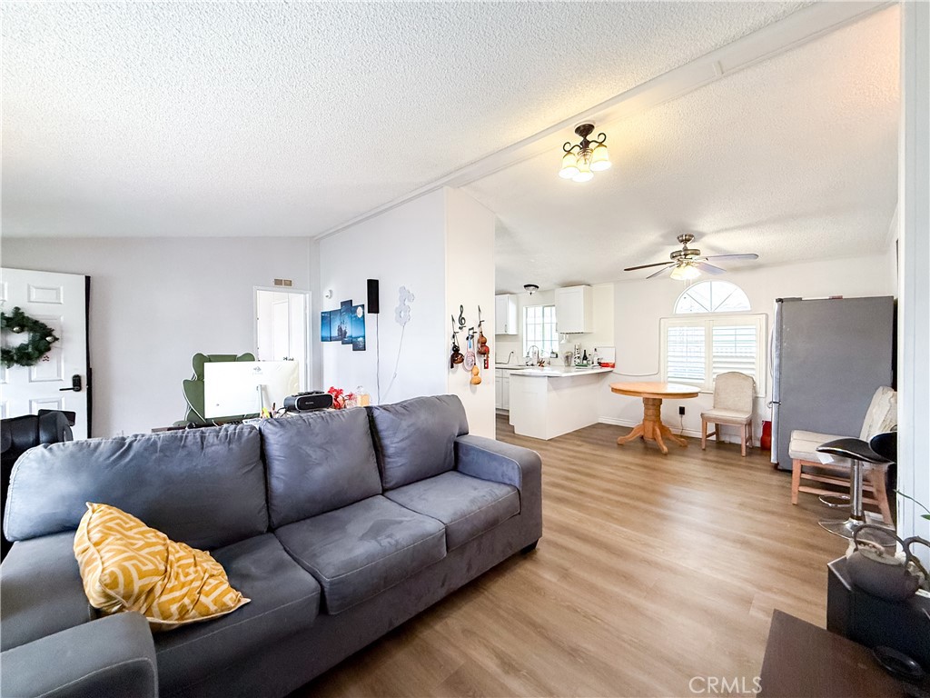1855 East Riverside, Unit 130 Ontario, CA 91761 - Photo 17 of 62 a living room with furniture and wooden floor
